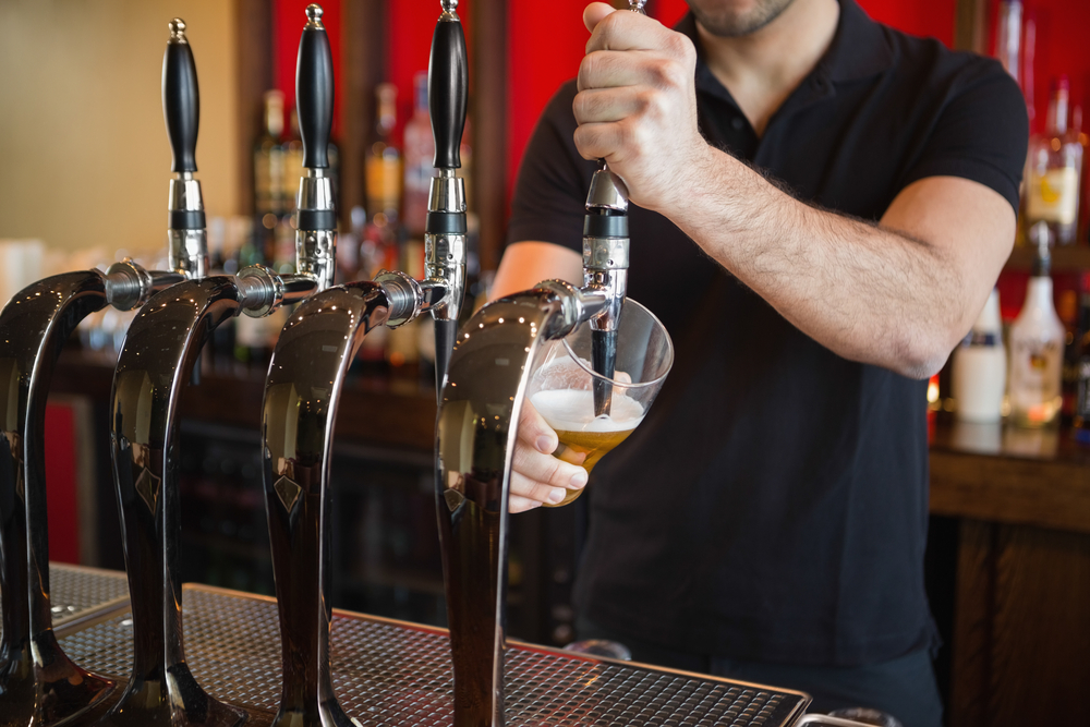 Prostate Cancer and Alcohol: What We Need to Know - Barkeeper pulling a pint of beer behind the bar
