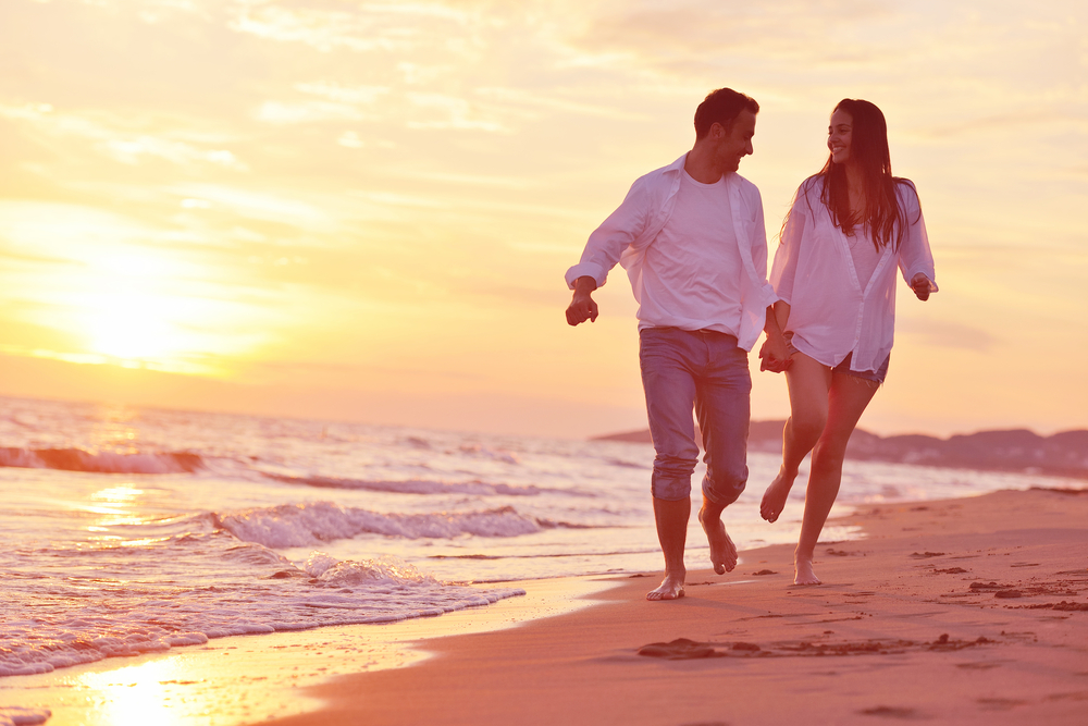 happy young romantic couple in love have fun on beautiful beach at beautiful summer day-1